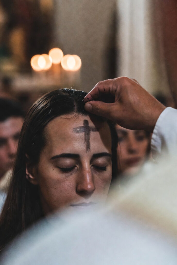 Ash cross on forehead during Ash Wednesday marking the beginning of the Lenten season